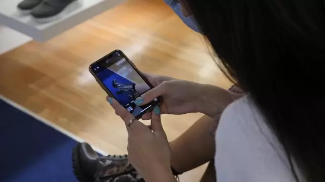 女人在商场给踝靴拍照视频素材插图